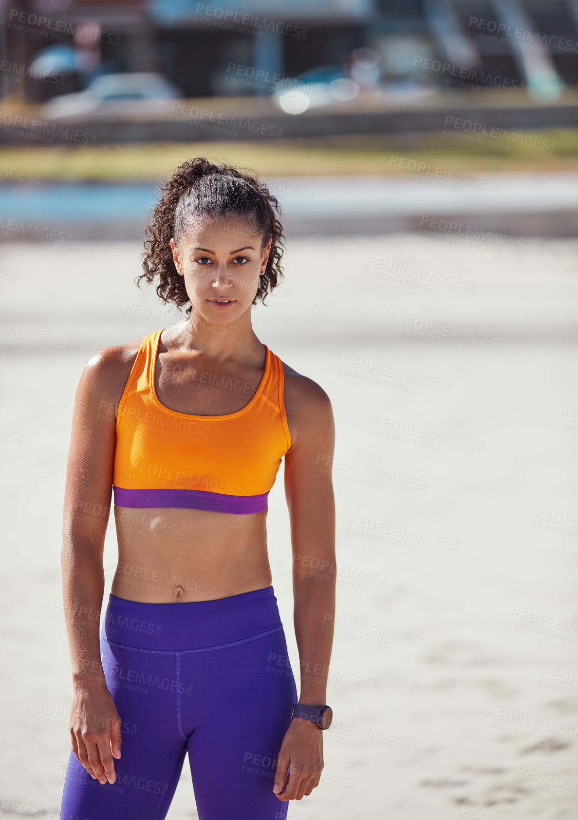 Buy stock photo Shot of a sporty young woman standing outside after her morning workout