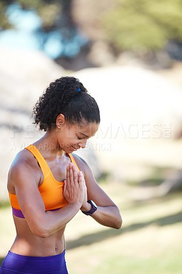 Buy stock photo Shot of an attractive young woman practising yoga at a park
