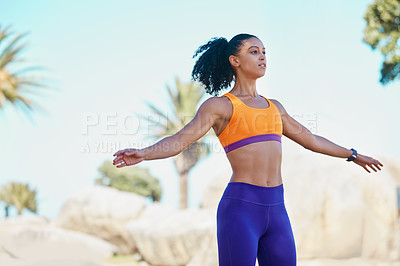 Buy stock photo Shot of a sporty young woman jumping into mid air