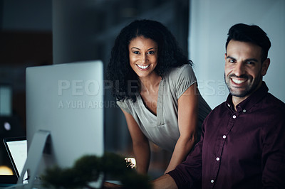Buy stock photo Portrait of two colleagues using a computer together during a late night at work