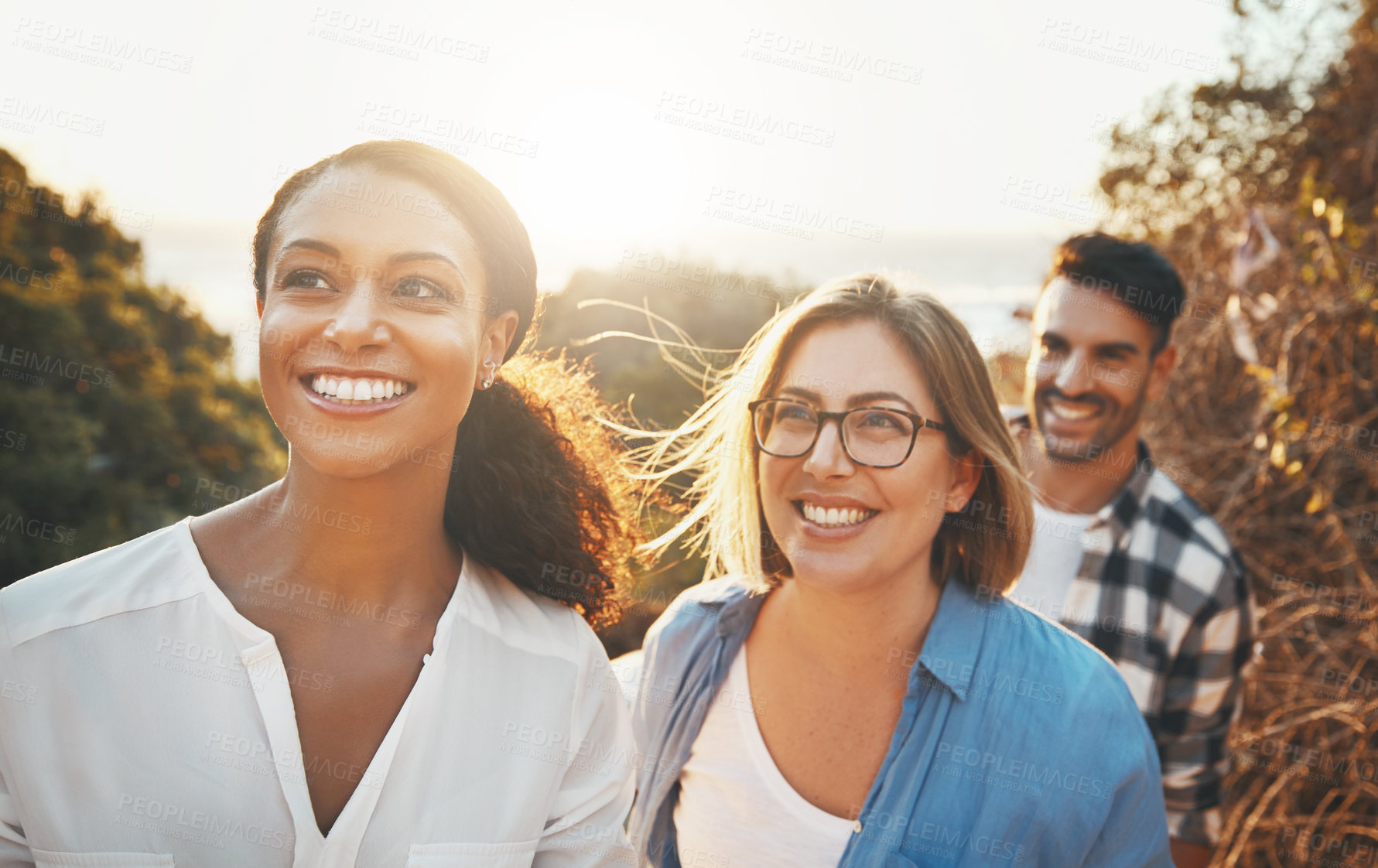 Buy stock photo Walking, nature and people with view, smile and friends with journey, explore and happiness. Outdoor, man and women with adventure, bonding together and support for hobby, sunshine and laughing