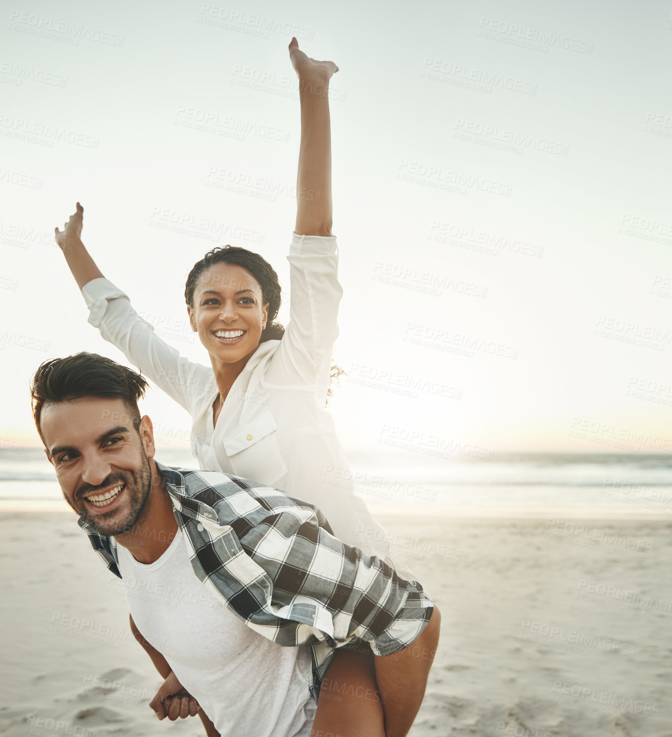 Buy stock photo Couple, playful and piggy back at beach with smile, love or connection for adventure on holiday. Man, woman and embrace on vacation, date and mockup space in nature by sea, waves or freedom at sunset