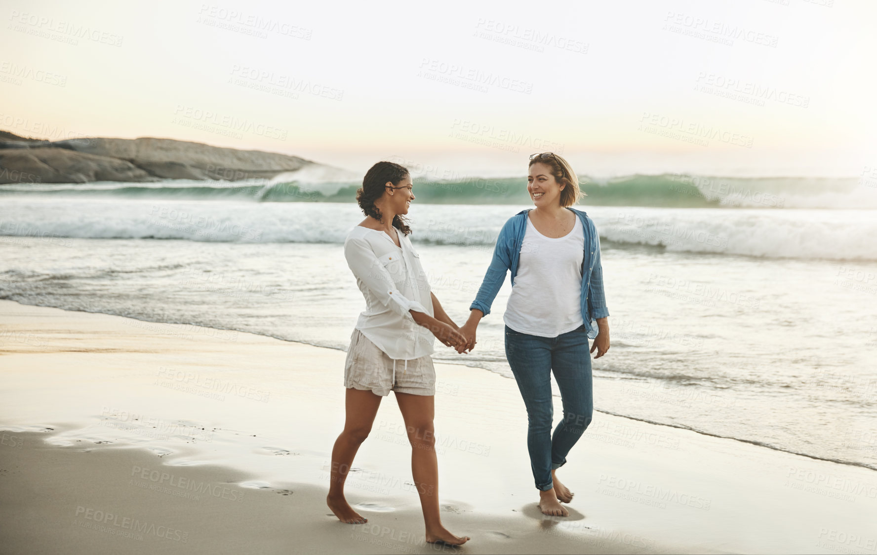 Buy stock photo Walking, couple and women in beach, lesbian and water on sand, vacation and holding hands with love. Summer, travel and waves in sea, holiday and peace of people, lgbtq and trust in adventure of date