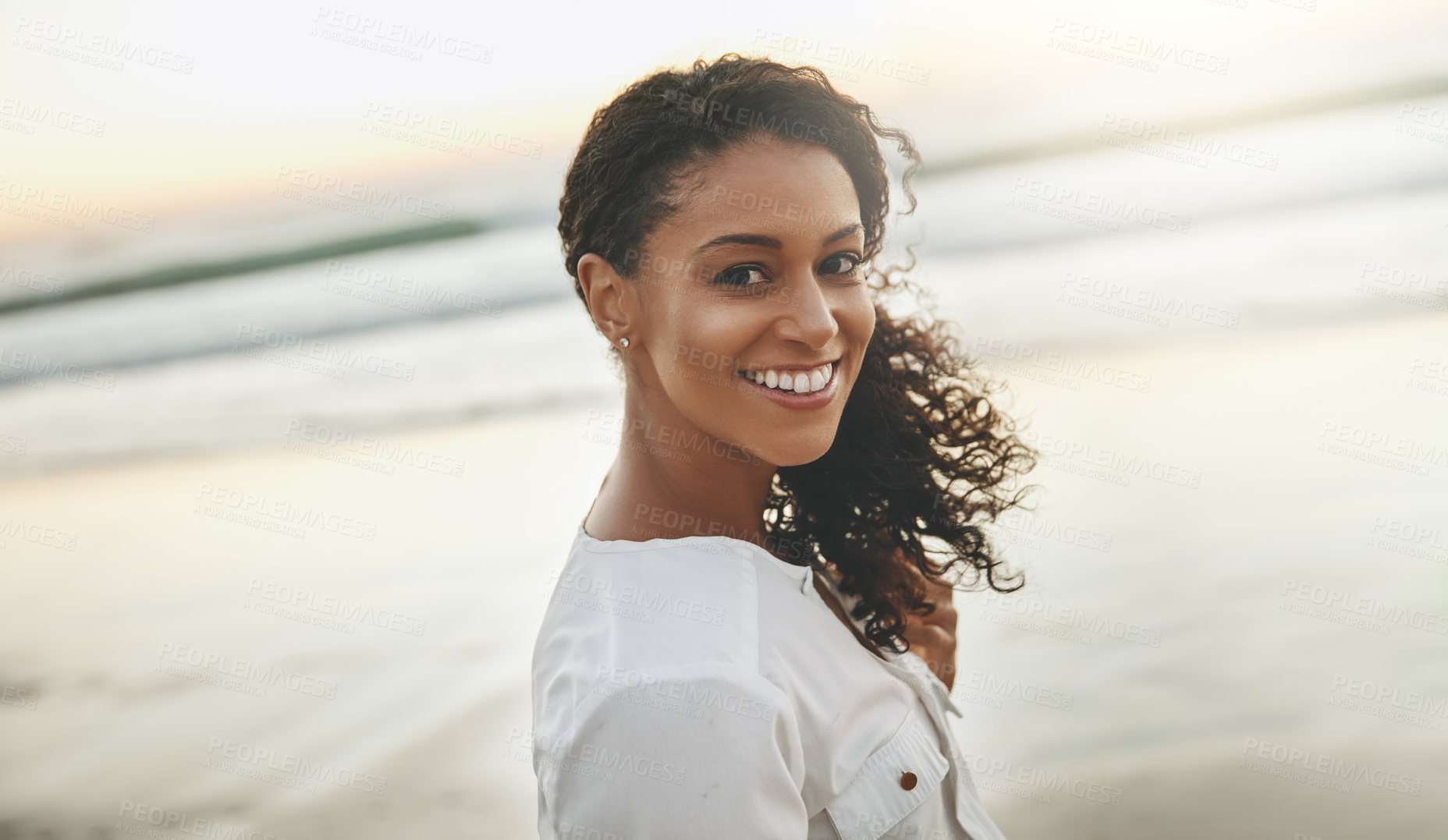 Buy stock photo Cropped shot of a young woman enjoying herself at the beach