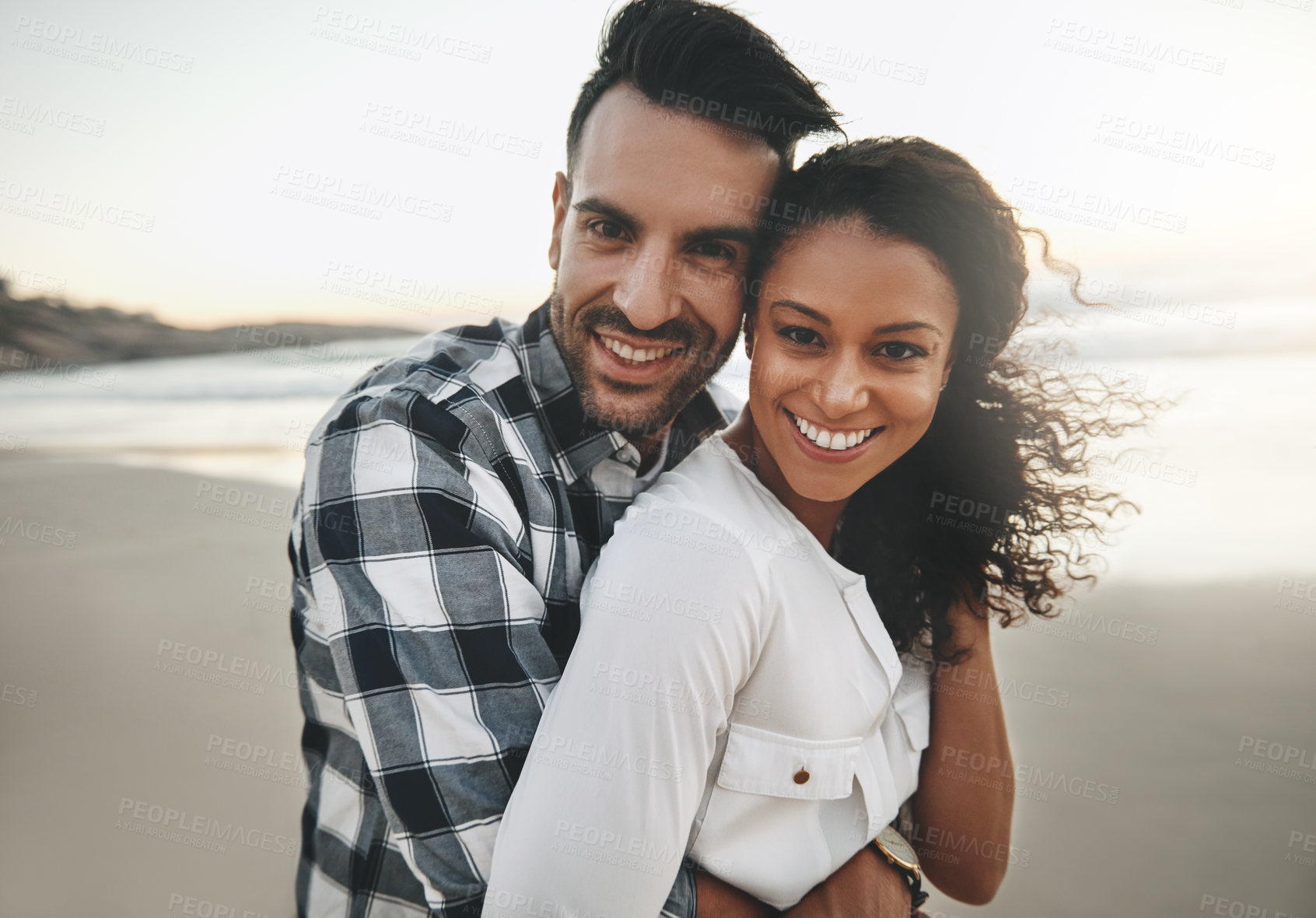 Buy stock photo Couple, hug and sunset at beach with portrait for care, love or connection for holiday in Brazil. Man, woman and embrace on vacation, date and outdoor in nature by ocean, excited or smile in sunshine