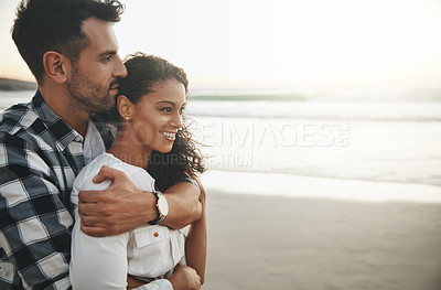 Buy stock photo Shot of a young man hugging his girlfriend from the back while spending the day outdoors