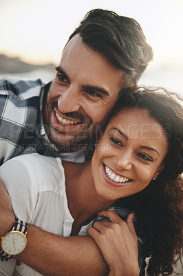 Buy stock photo Shot of a young man hugging his girlfriend from the back while spending the day outdoors