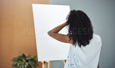 Buy stock photo Rearview shot of a young woman looking frustrated while trying to paint on a canvas at home