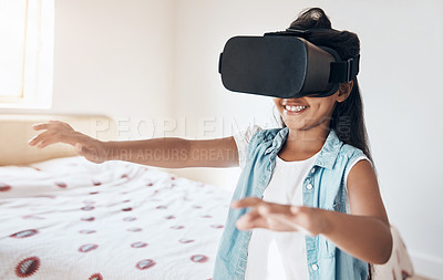 Buy stock photo Shot of a young girl using a virtual reality headset at home