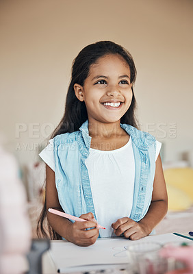 Buy stock photo Shot of a cute young girl drawing on paper at home