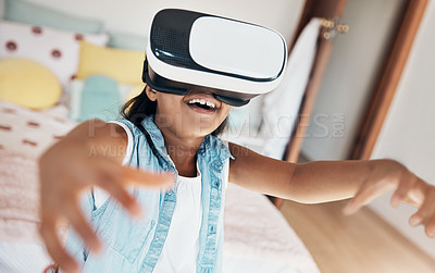 Buy stock photo Shot of a young girl using a virtual reality headset at home