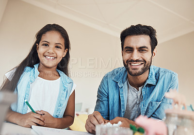 Buy stock photo Shot of a cute young girl and her father drawing on paper together at home