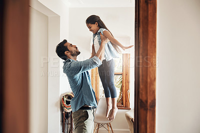 Buy stock photo Shot of a happy father and daughter playing together at home