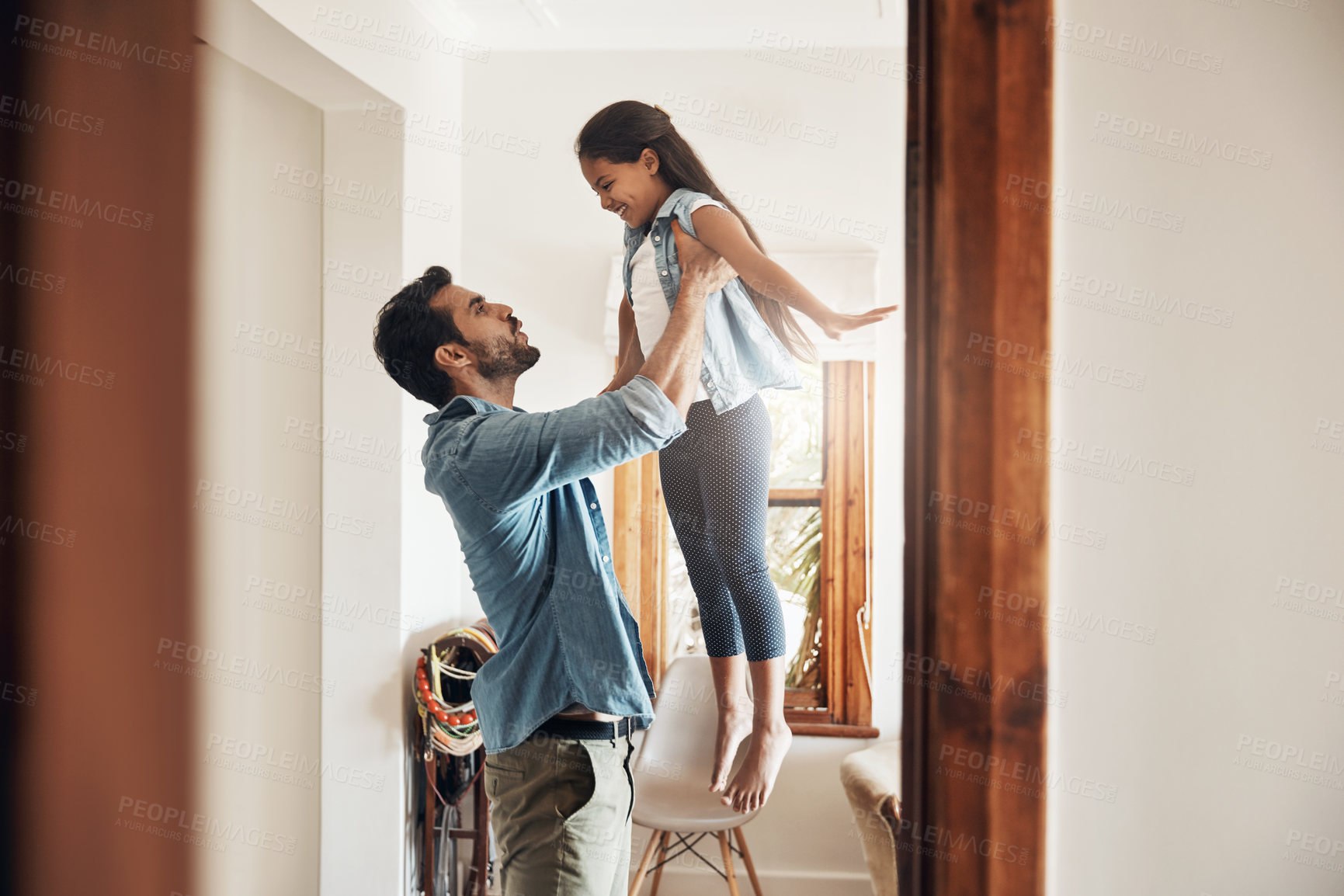 Buy stock photo Father, play and happy kid in up in air with fun, love and bonding together in family home with smile. Morning, man and airplane game with care, funny and young girl with laugh and flying in lounge 