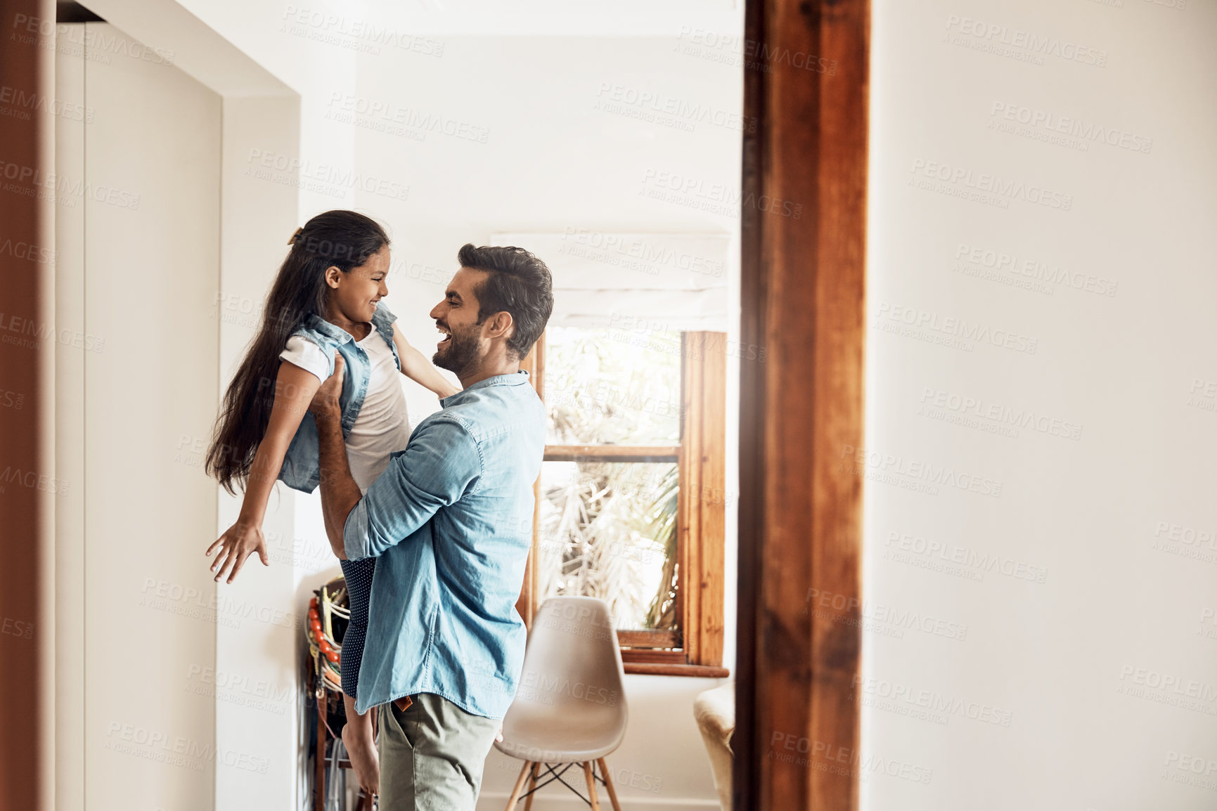 Buy stock photo Shot of a happy father and daughter playing together at home