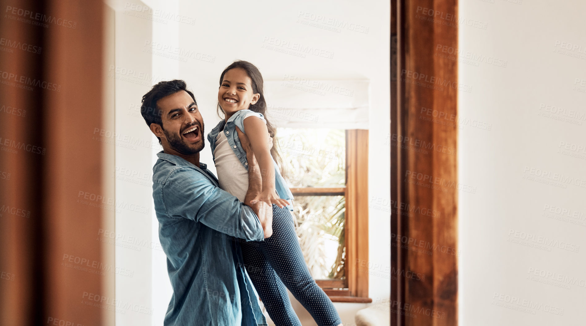 Buy stock photo Shot of a happy father and daughter playing together at home