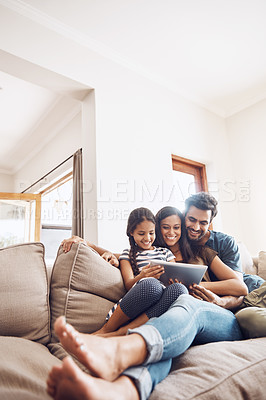 Buy stock photo Love, smile and family on a couch, tablet and happiness at home, relax and connection for social media. Parents, happy mother and father on a sofa, technology and online reading with a female child