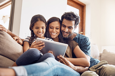 Buy stock photo Happy family, people with tablet on sofa bonding and in living room in their home. Love or care, communication with technology and social media or movie streaming with mobile device on couch