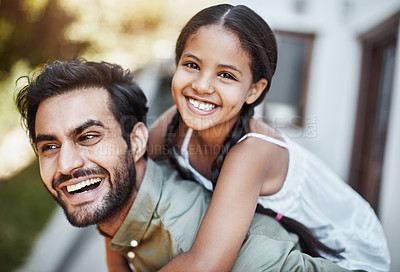 Buy stock photo Shot of a happy father and daughter enjoying a piggyback ride together outdoors