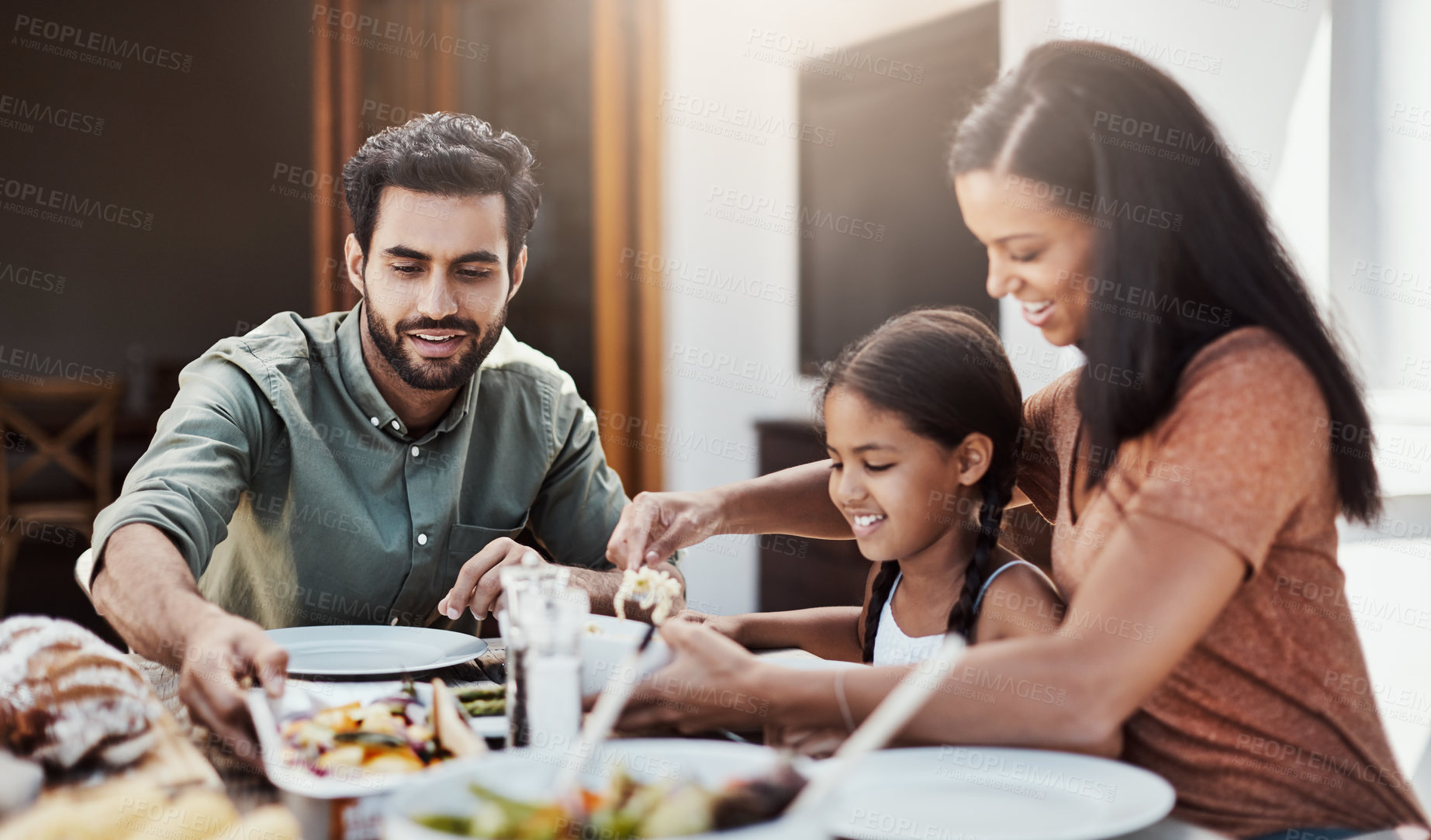 Buy stock photo Parents, kid and happy in home for dinner with food in dining table and bonding. Family, people and smile for support with care or trust and gather to relax, chill and laugh with conversation