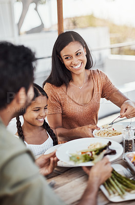 Buy stock photo Parents, child and happy in home for lunch with food in dining table and bonding. Family, people and smile for eating with care or trust and gathering to relax, chill and satisfied with meal