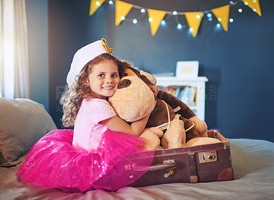 Buy stock photo Portrait of an adorable little girl dressed up as a sailor and playing on the bed at home