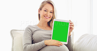 Buy stock photo Shot of a pregnant woman holding up a tablet at home