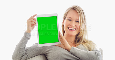 Buy stock photo Shot of an attractive young woman holding up a tablet at home