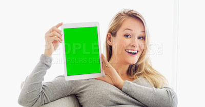 Buy stock photo Shot of an attractive young woman holding up a tablet in at home