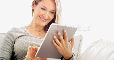 Buy stock photo Cropped portrait of an attractive young woman using a tablet in her home