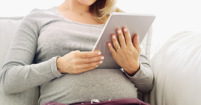 Buy stock photo Shot of an unrecognizable  pregnant woman using a tablet at home