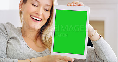 Buy stock photo Cropped portrait of an attractive young woman holding up a tablet at home
