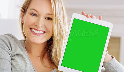 Buy stock photo Cropped portrait of an attractive young woman holding up a tablet at home