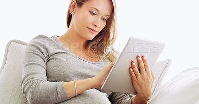 Buy stock photo Shot of a pregnant woman using a tablet at home