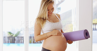 Buy stock photo Cropped shot of an attractive young pregnant woman carrying a yoga mat