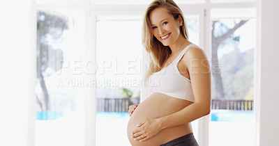 Buy stock photo Cropped portrait of an attractive young pregnant woman rubbing her baby bump