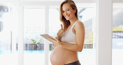 Buy stock photo Shot of a pregnant woman using a tablet at home