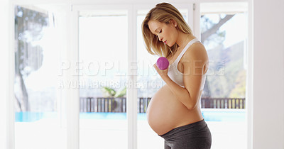 Buy stock photo Cropped shot of an attractive young pregnant woman working out with dumbbells
