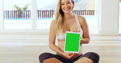 Buy stock photo Shot of a pregnant woman holding up a tablet at home