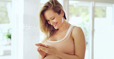 Buy stock photo Shot of a pregnant woman using a cellphone at home