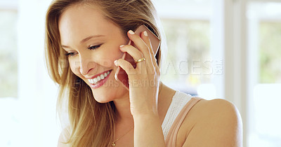 Buy stock photo Cropped shot of an attractive young woman making a call on a cellphone at home