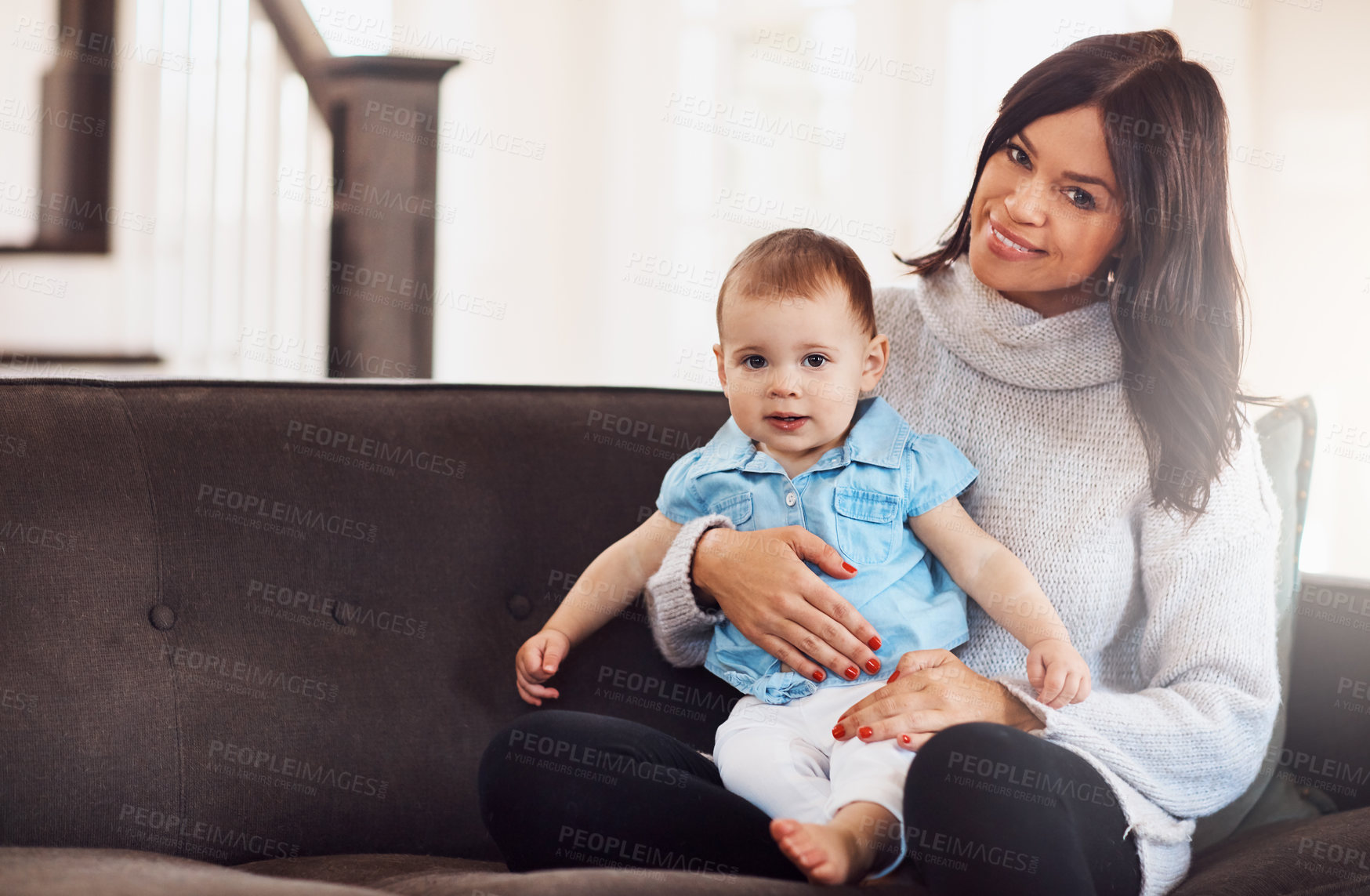 Buy stock photo Portrait, baby and mother on sofa in living room, holding hands for love and bonding for support. Smile, motherhood and toddler with woman together, hug and play by sitting for relationship at home