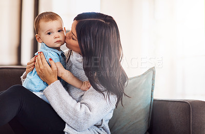 Buy stock photo Mom, baby and kiss in sofa for bonding or support with love, growth and child development. Parent, toddler and happy at home with care, childhood memories and together with trust and smile on couch
