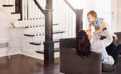 Buy stock photo Shot of an adorable baby girl bonding with her mother on the sofa at home