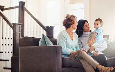 Buy stock photo Mother, baby and grandmother on sofa with love, care and bonding with safety, security and conversation in their home. Family, generations and kid with mom, grandma and games chilling in living room