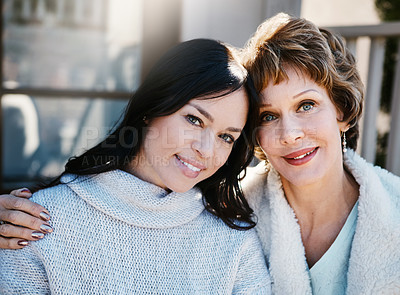 Buy stock photo Shot of a happy young woman spending quality time with her mother