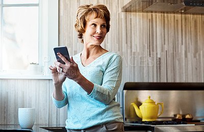 Buy stock photo Phone, thinking and senior woman in kitchen with smile, connection or scroll on social media. Morning, relax and elderly person in home with smartphone, online chat or mobile app for communication