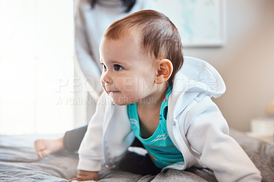 Buy stock photo Shot of an adorable baby girl playing on the bed at home