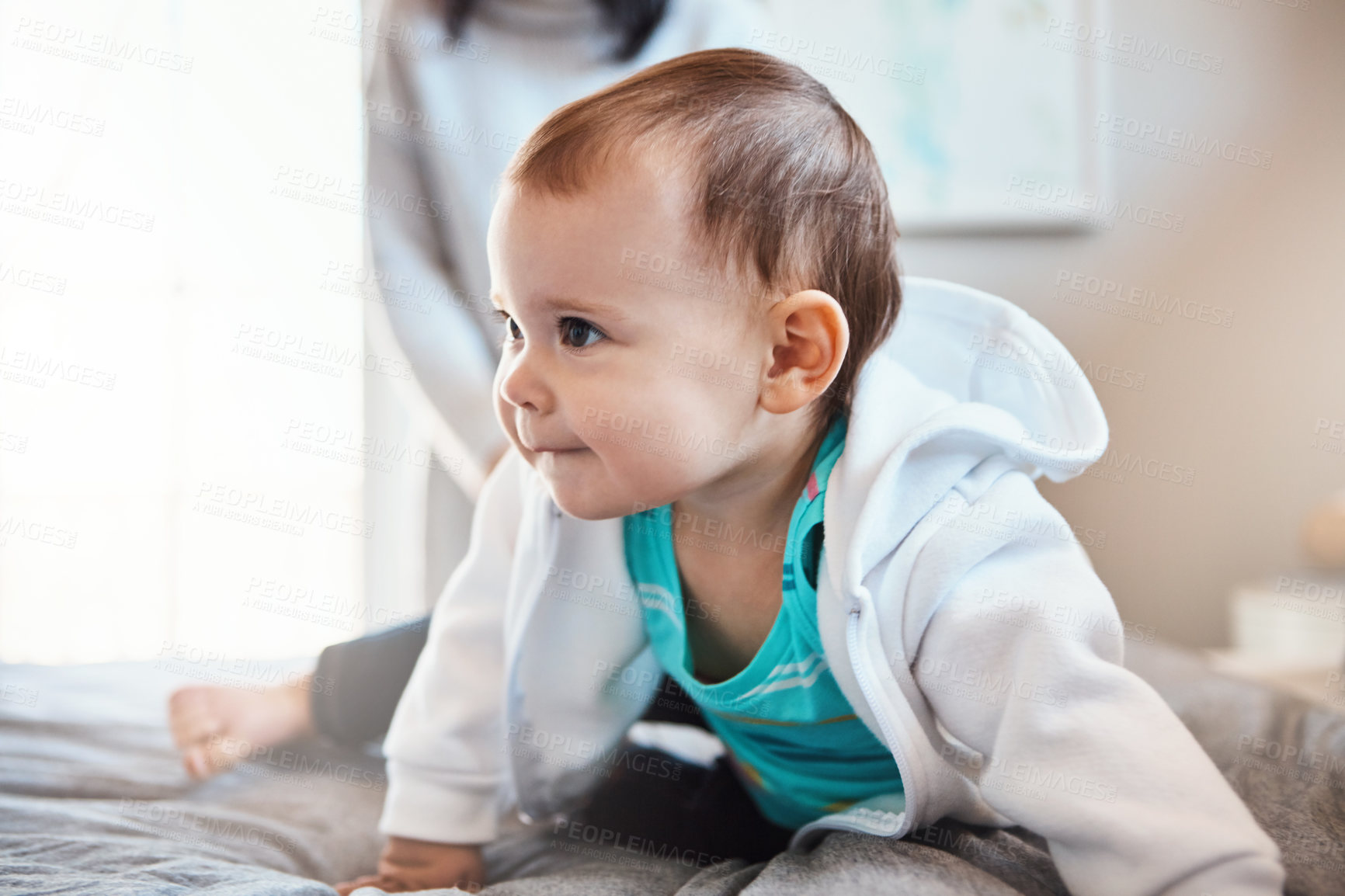 Buy stock photo Shot of an adorable baby girl playing on the bed at home