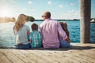 Buy stock photo Family, lake and pier on vacation for bonding, peace and travel to relax by water together. Parents, children and love on holiday by river or care in nature, back and outdoor for relationship on trip